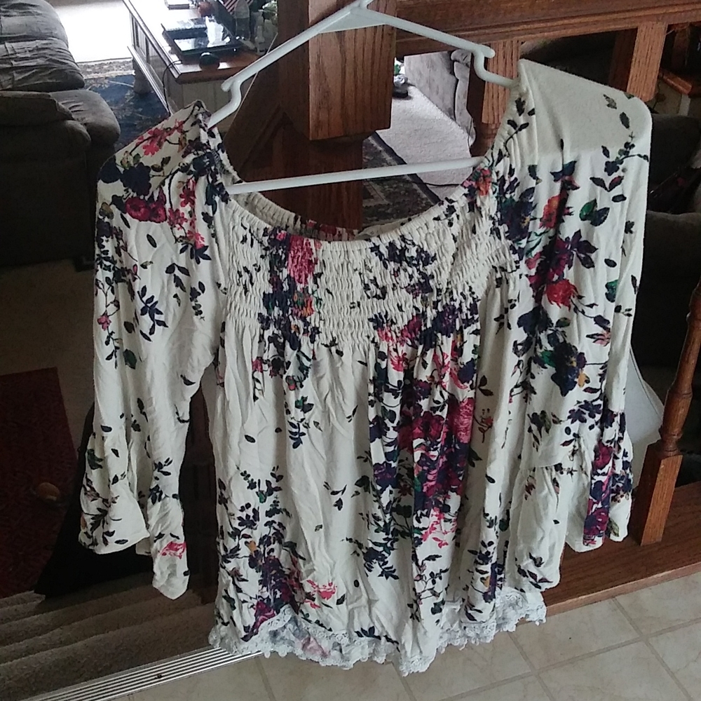 Long sleeve shirt, flowy sleeves. White with pink and purple flowers on it.